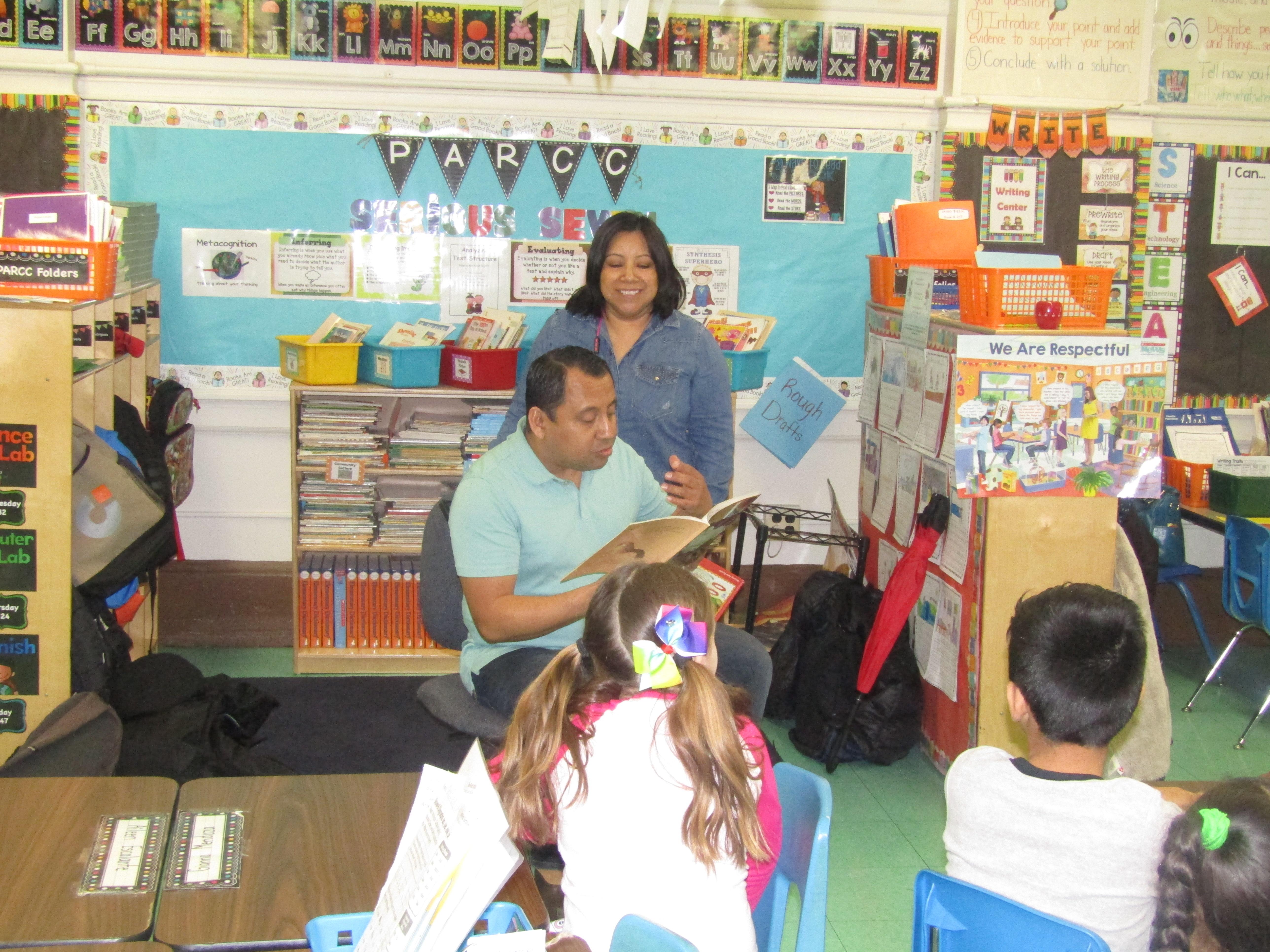 mom & Dad reading to their child's class