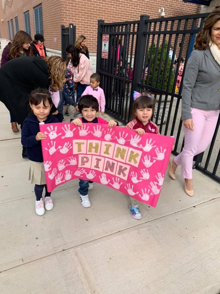 three kids holding a sign that says think pink