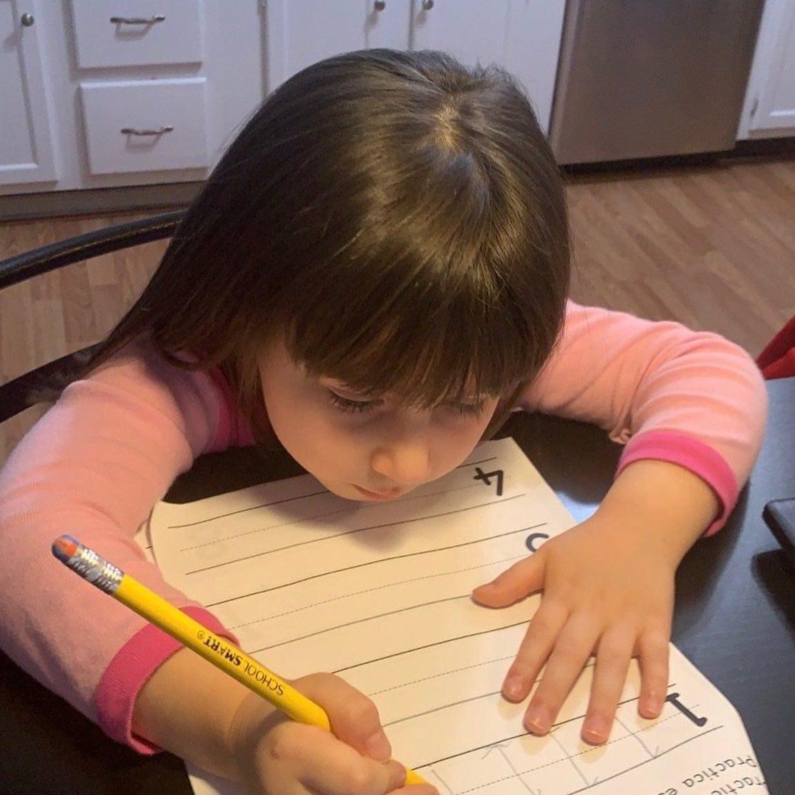 close up of a girl in her kitchen writing her numbers